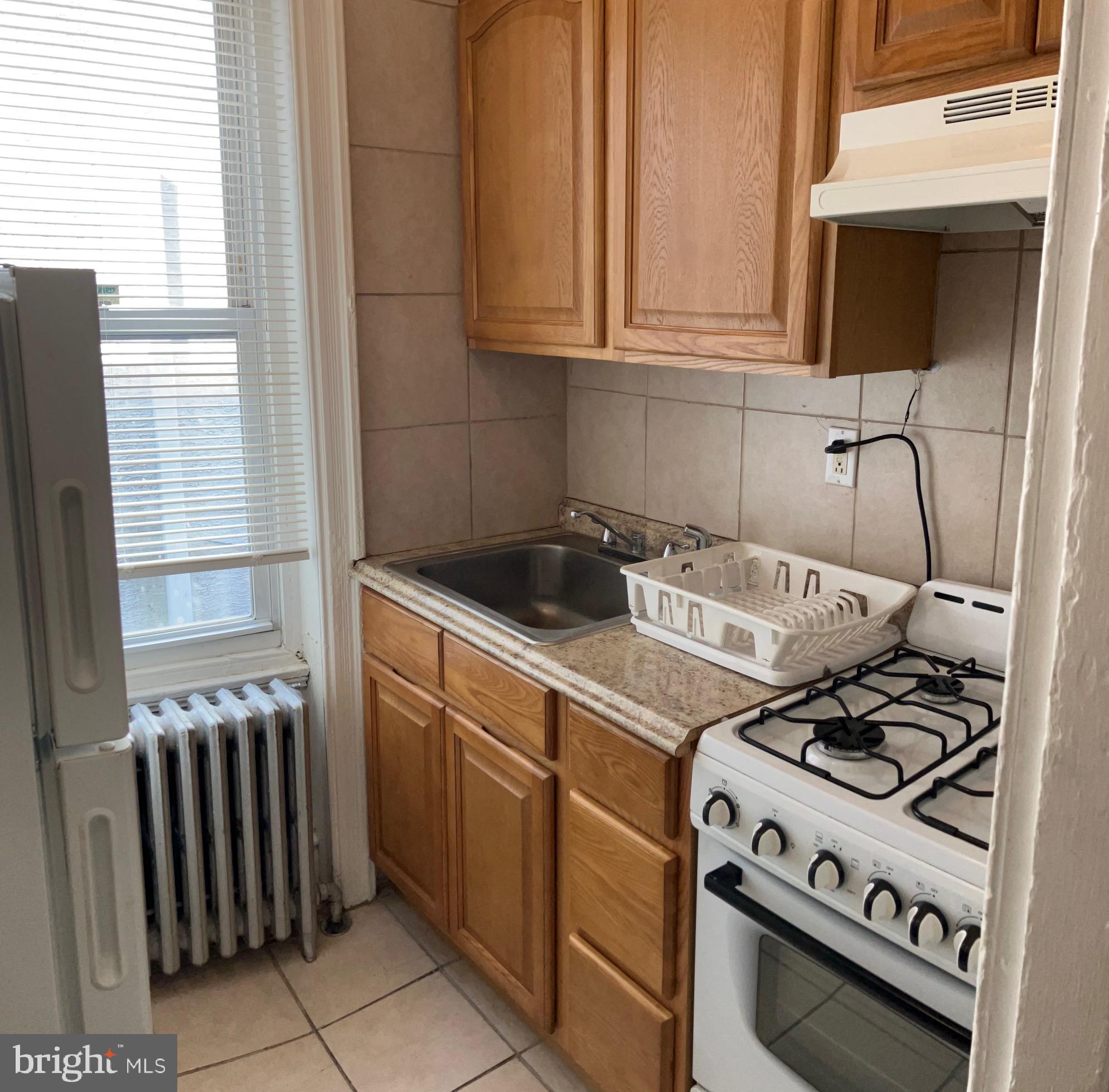 2215 Catharine Street, Unit 2 Philadelphia, PA 19146 - Photo 9 of 11 a kitchen with a stove and a microwave