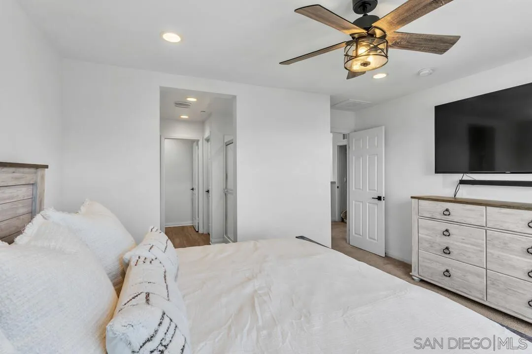 2811 Safflower Street Spring Valley, CA 91977 - Photo 18 of 28 a bedroom with a bed and a flat screen tv