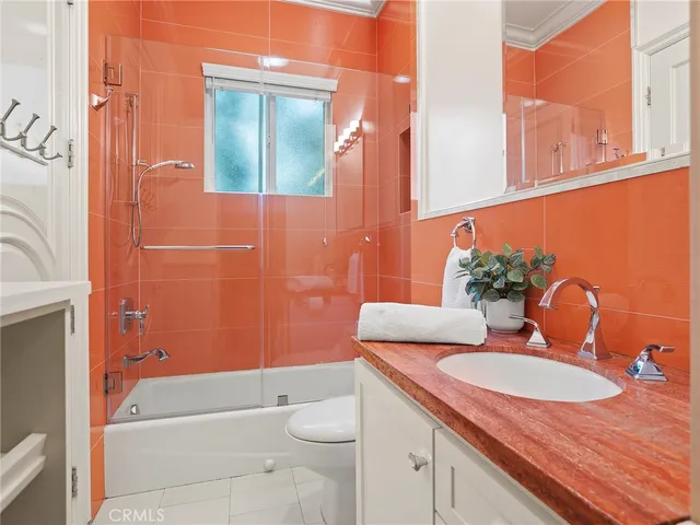 a view of a house with a yard and potted plants