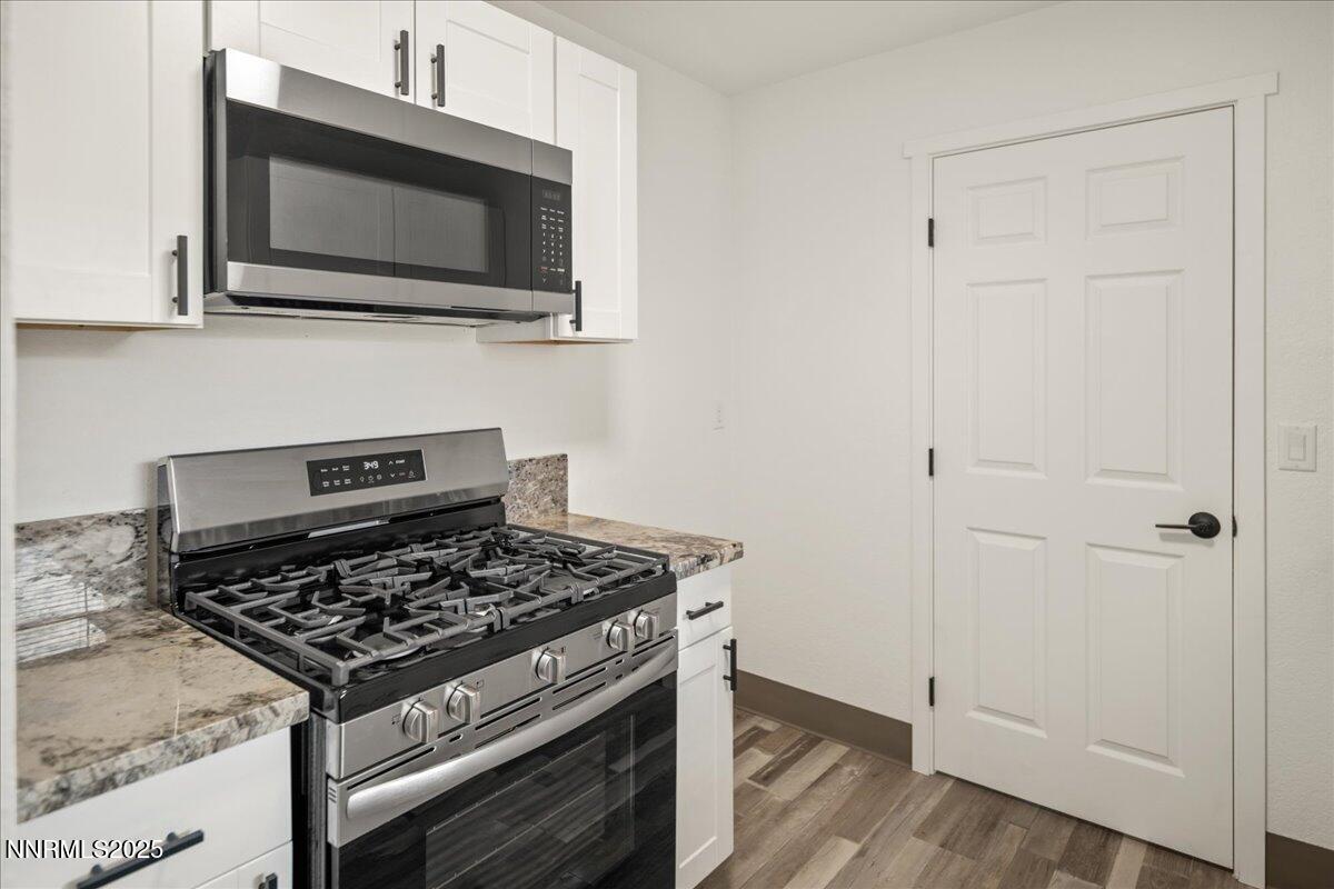 10038 Humite Lane Reno, NV 89506 - Photo 12 of 30 a kitchen with a stove and a microwave