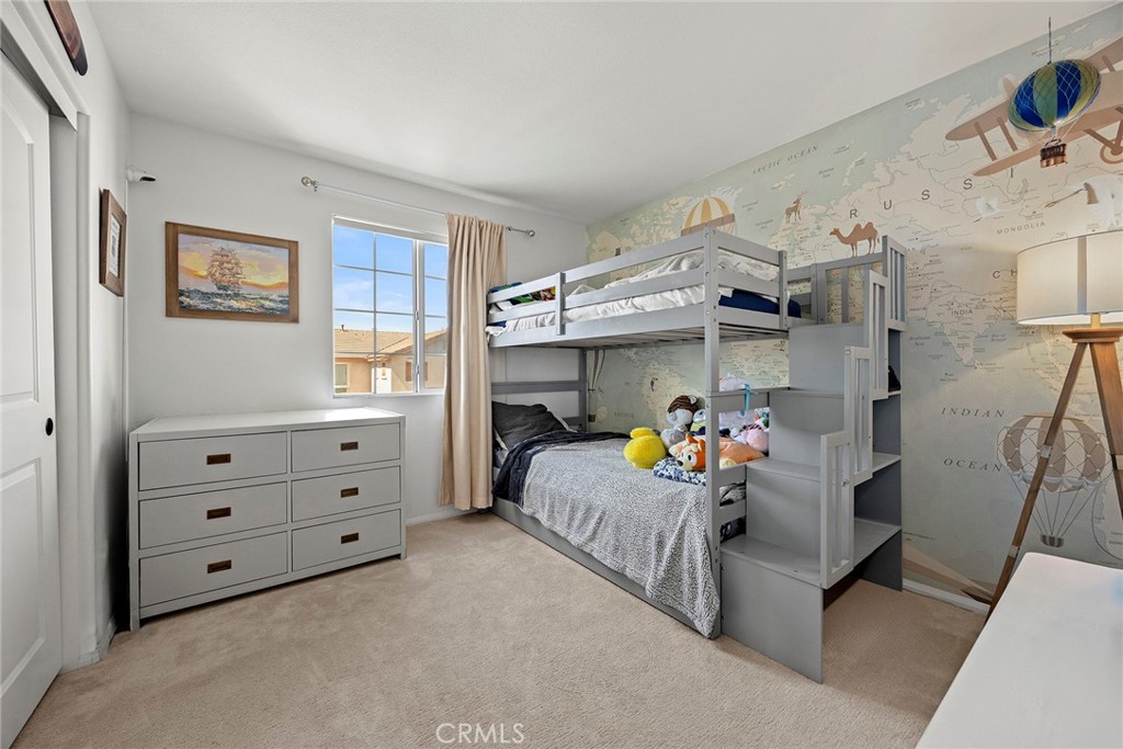 7357 Max Way Eastvale, CA 92880 - Photo 16 of 39 a bedroom with a bed and a window