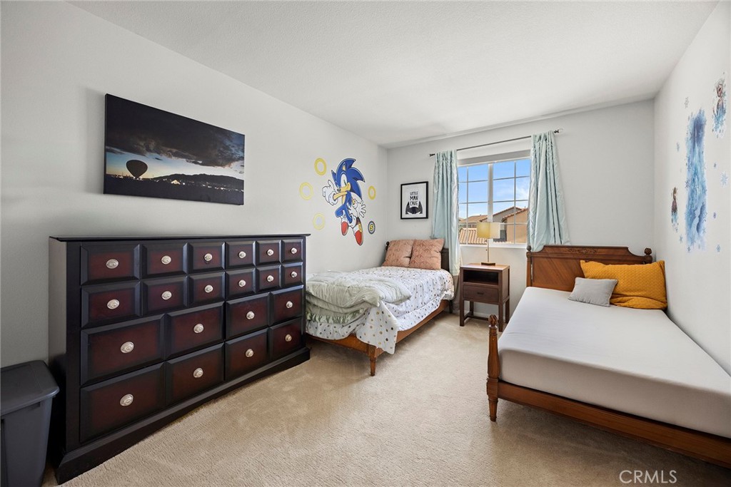 7357 Max Way Eastvale, CA 92880 - Photo 20 of 39 a bedroom with a bed and a couch