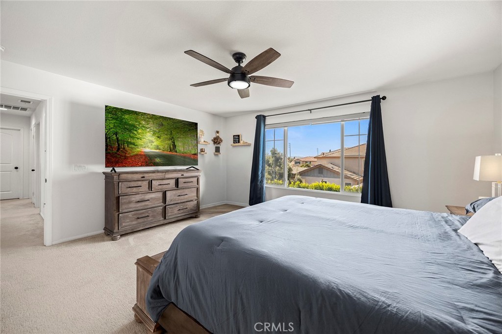 7357 Max Way Eastvale, CA 92880 - Photo 23 of 39 a bedroom with a bed and a flat screen tv