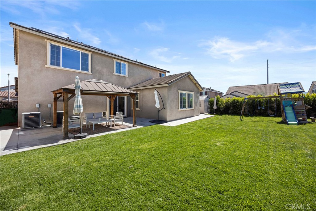 7357 Max Way Eastvale, CA 92880 - Photo 27 of 39 a front view of house with yard and green space