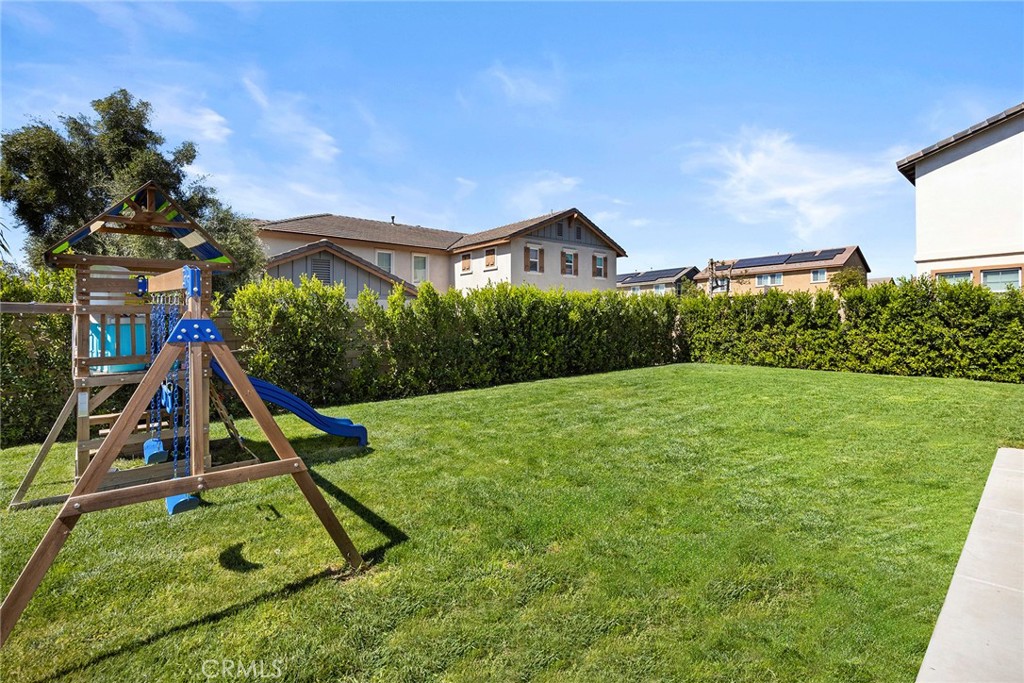 7357 Max Way Eastvale, CA 92880 - Photo 30 of 39 a view of a house with a backyard and a slide