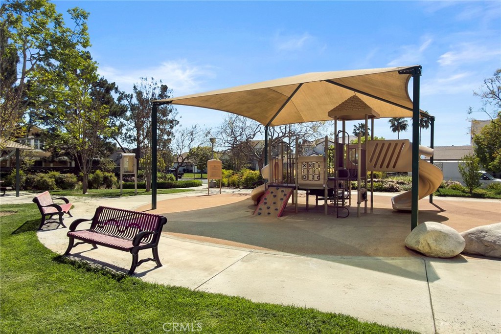 7357 Max Way Eastvale, CA 92880 - Photo 36 of 39 a sitting area with a table and chairs under an umbrella