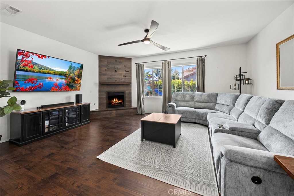 7357 Max Way Eastvale, CA 92880 - Photo 4 of 39 a living room with furniture flat screen tv and a fireplace