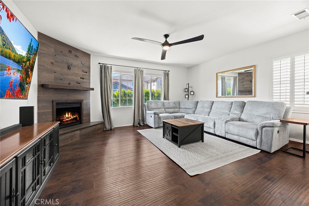 7357 Max Way Eastvale, CA 92880 - Photo 5 of 39 a living room with furniture and a fireplace