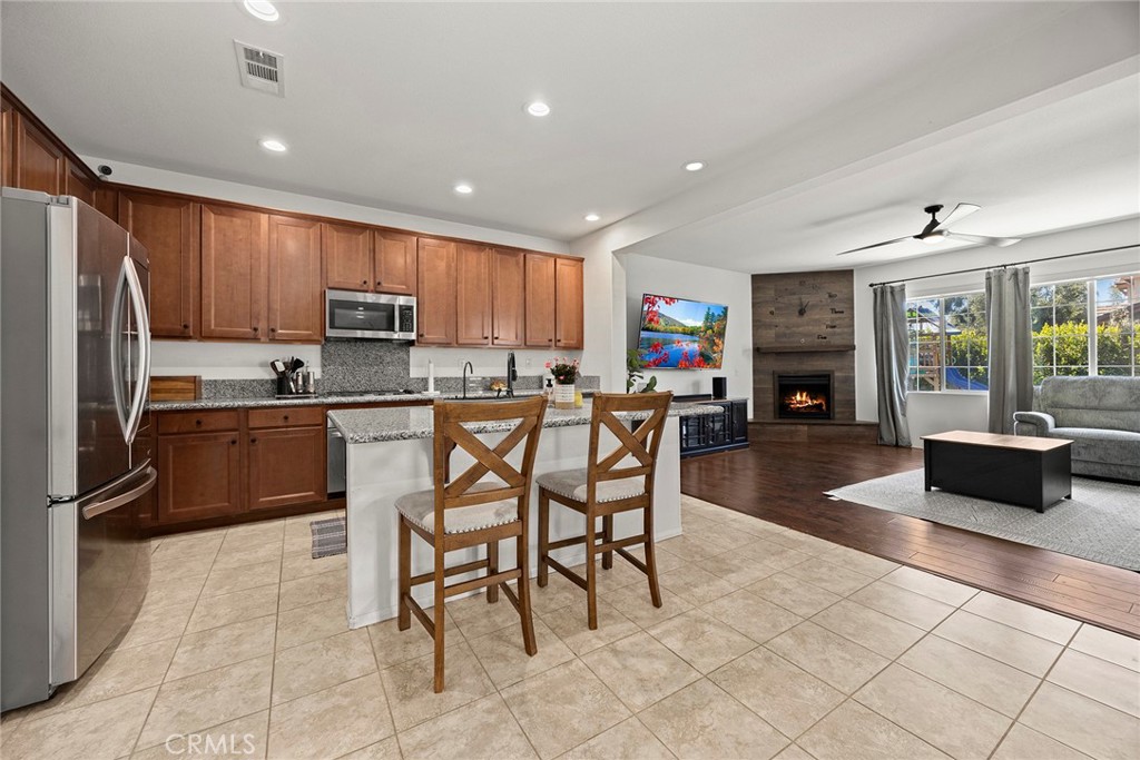 7357 Max Way Eastvale, CA 92880 - Photo 8 of 39 a kitchen with a refrigerator and a stove top oven