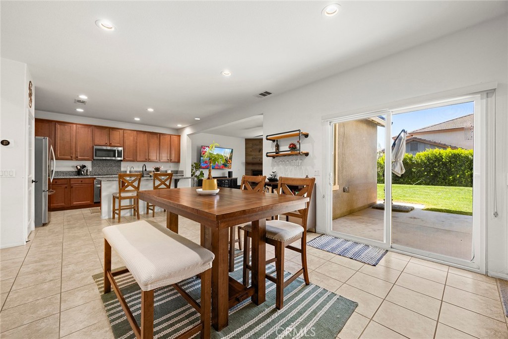7357 Max Way Eastvale, CA 92880 - Photo 10 of 39 a view of a dining room kitchen with furniture and a kitchen