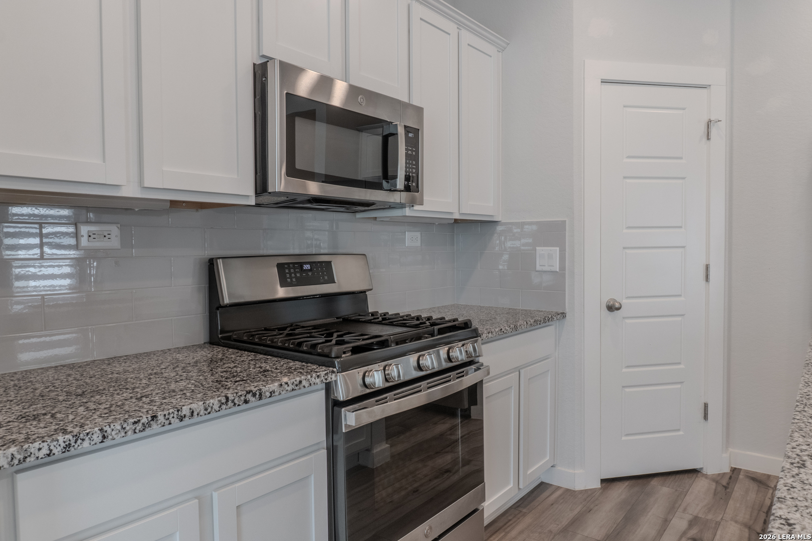 175 Ryan Crossing San Antonio, TX 78253 - Photo 11 of 37 a kitchen with stainless steel appliances granite countertop white cabinets and a stove top oven