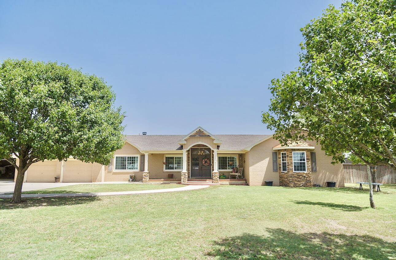 1308 West 24th Street Plainview, TX 79072 - Photo 1 of 85 a front view of a house with a garden and yard