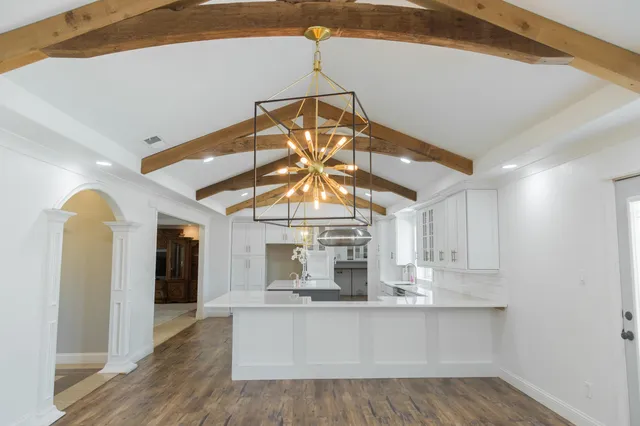 a kitchen with white cabinets and a sink