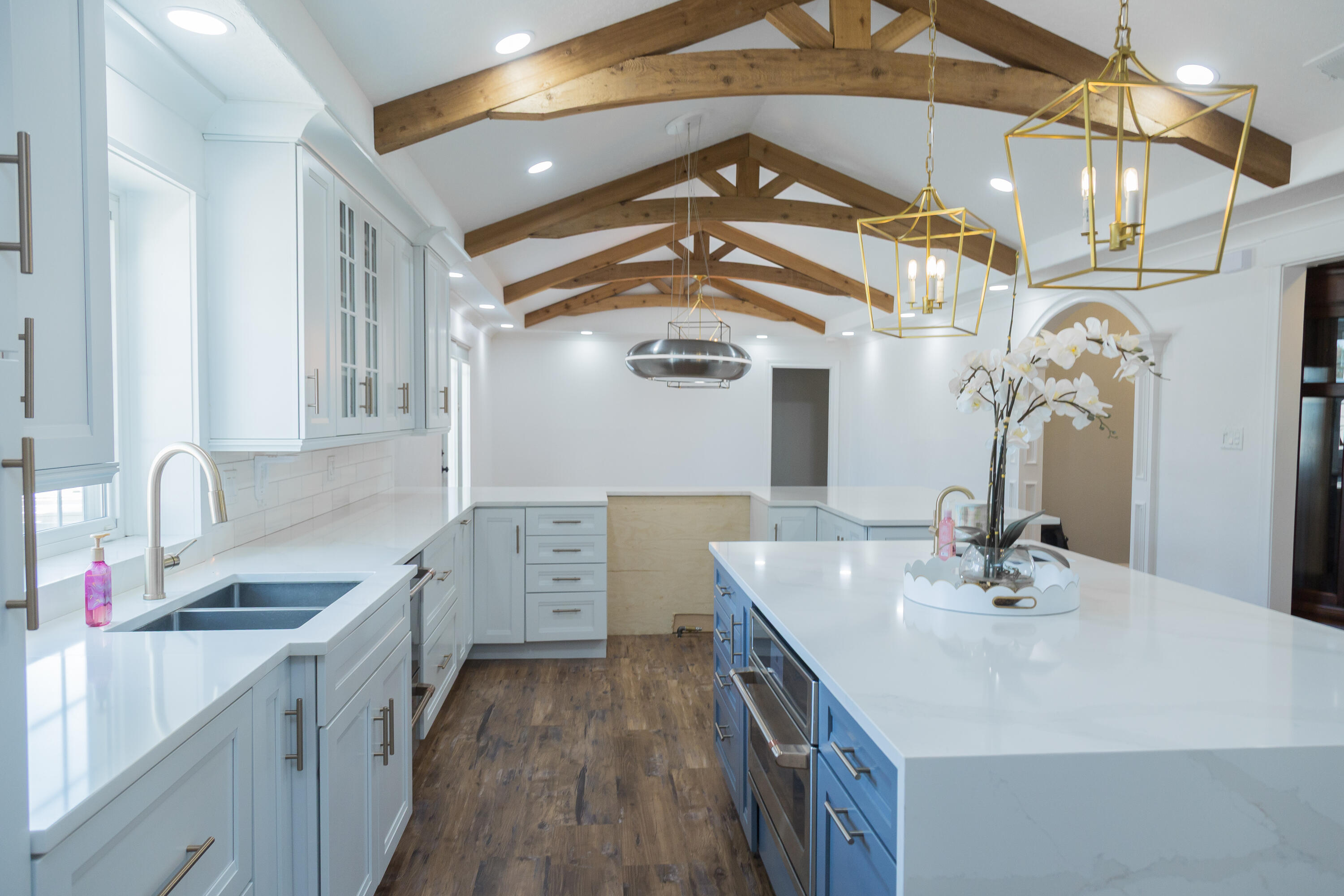 1308 West 24th Street Plainview, TX 79072 - Photo 24 of 85 a kitchen with a sink dishwasher a stove and a refrigerator with wooden floor