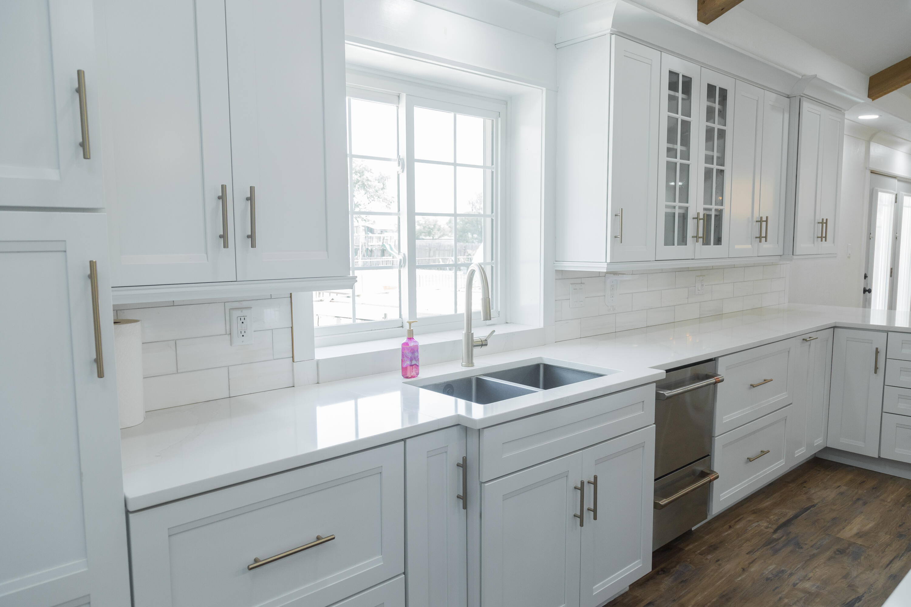 1308 West 24th Street Plainview, TX 79072 - Photo 26 of 85 a kitchen with white cabinets and a sink