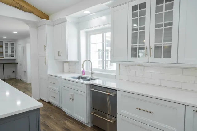 a living room with a fireplace and windows