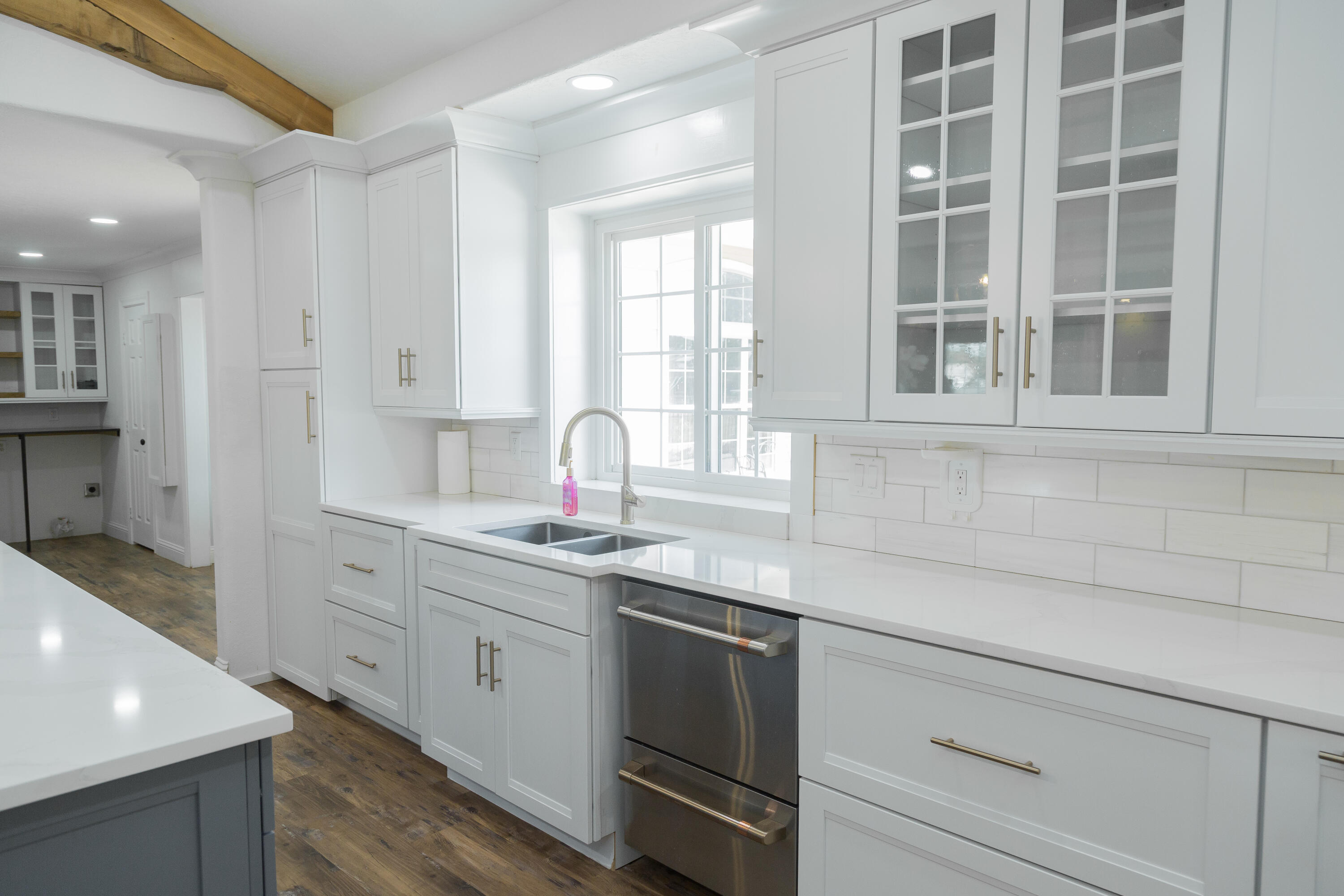 1308 West 24th Street Plainview, TX 79072 - Photo 27 of 85 a kitchen with stainless steel appliances granite countertop white cabinets and window