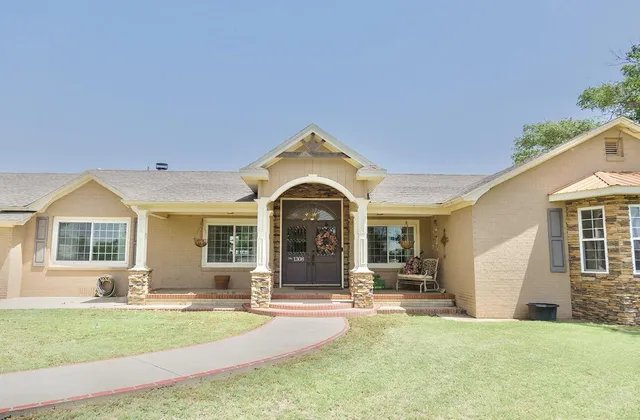 a view of a house with swimming pool and porch