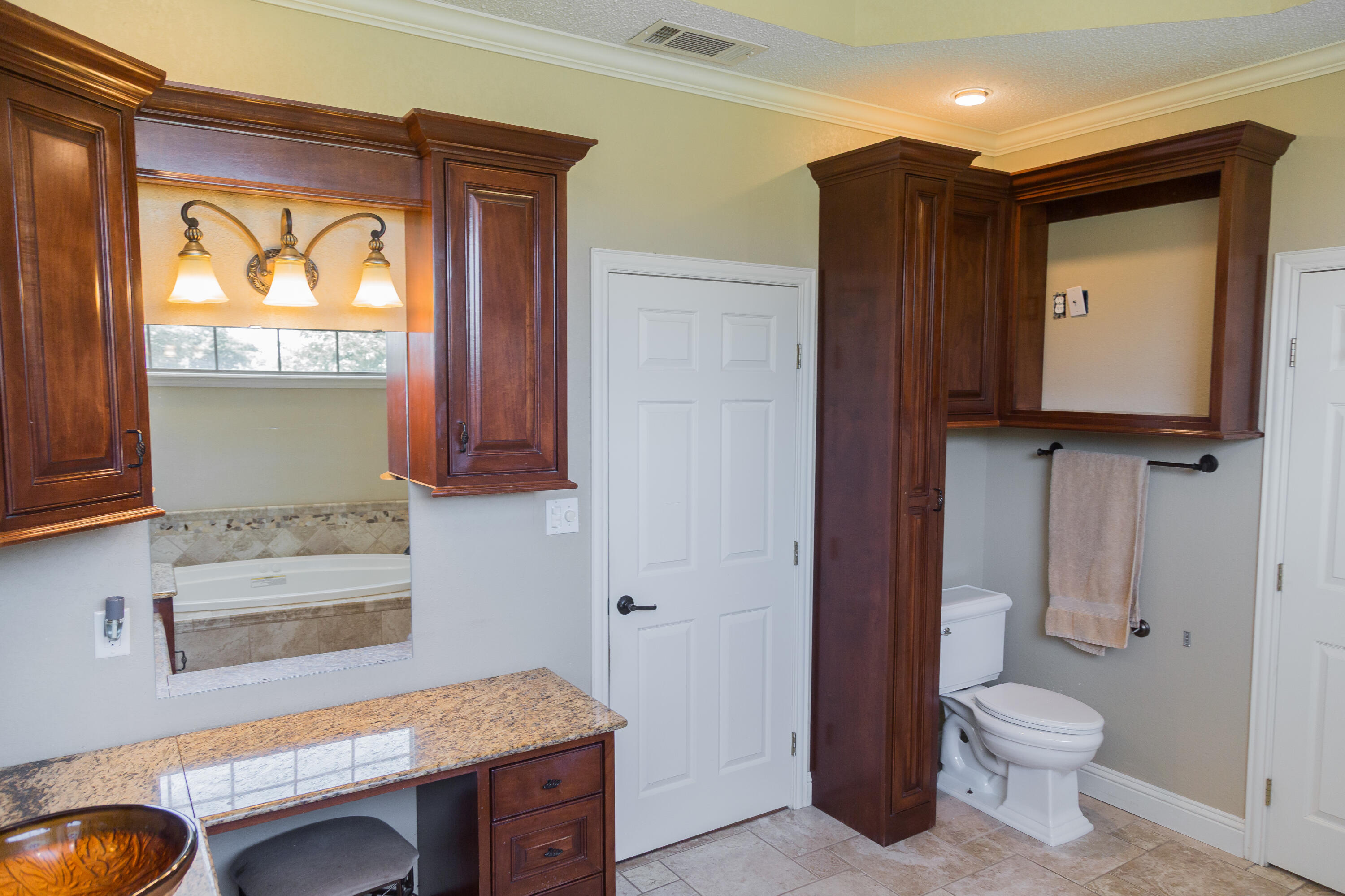 1308 West 24th Street Plainview, TX 79072 - Photo 50 of 85 a bathroom with a toilet a sink and a mirror