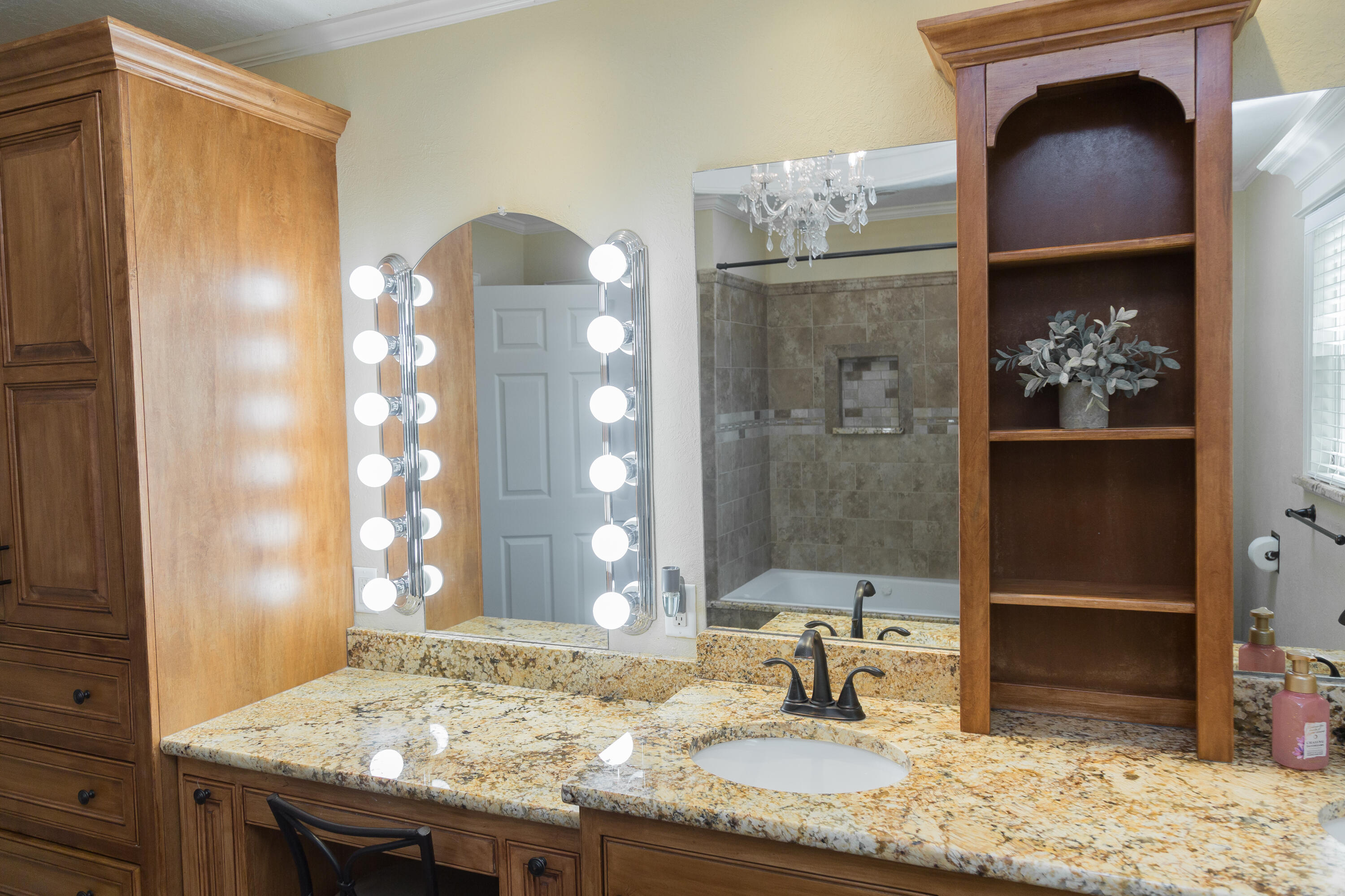 1308 West 24th Street Plainview, TX 79072 - Photo 62 of 85 a bathroom with a granite countertop sink and a mirror