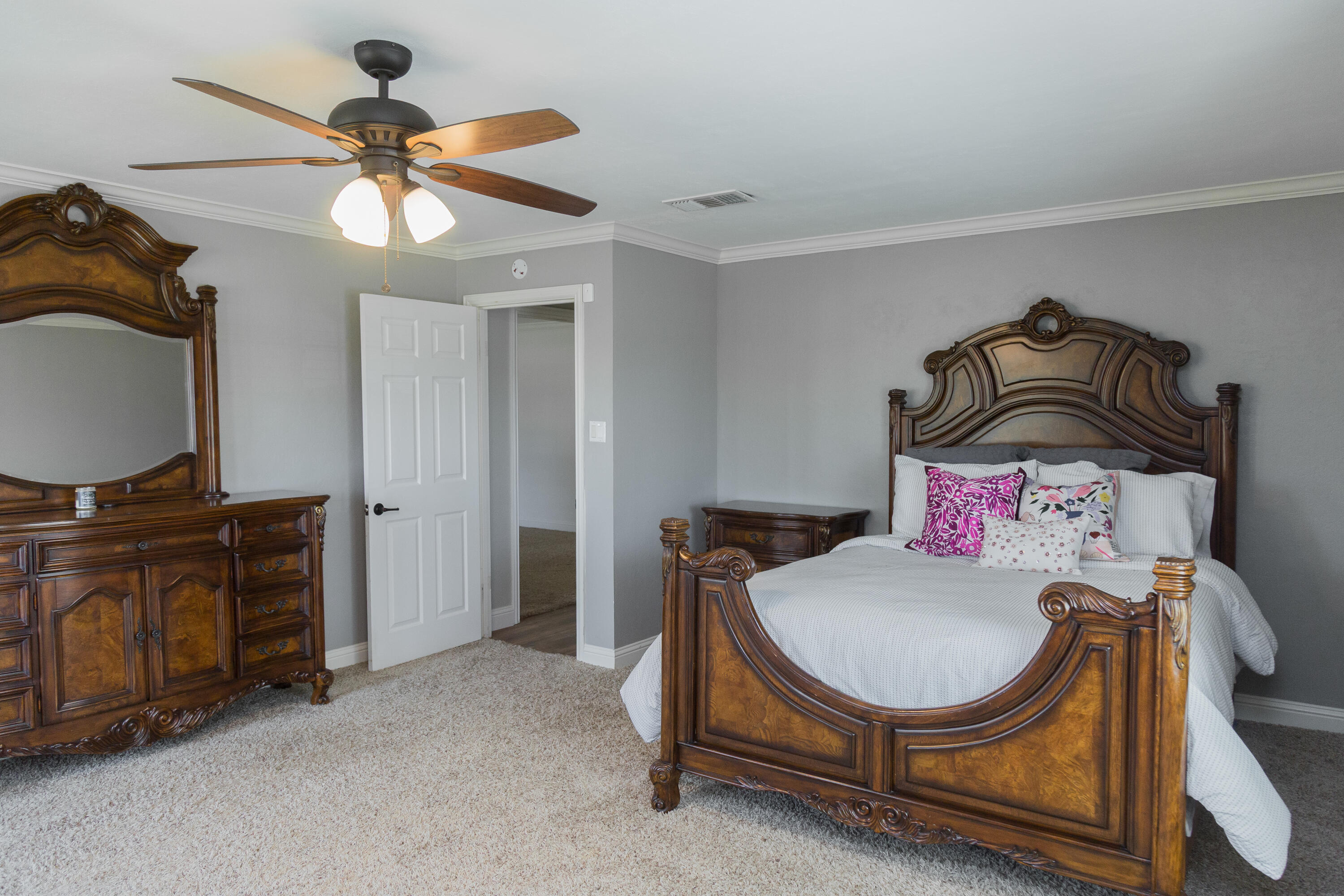 1308 West 24th Street Plainview, TX 79072 - Photo 67 of 85 a bedroom with a bed and a chandelier