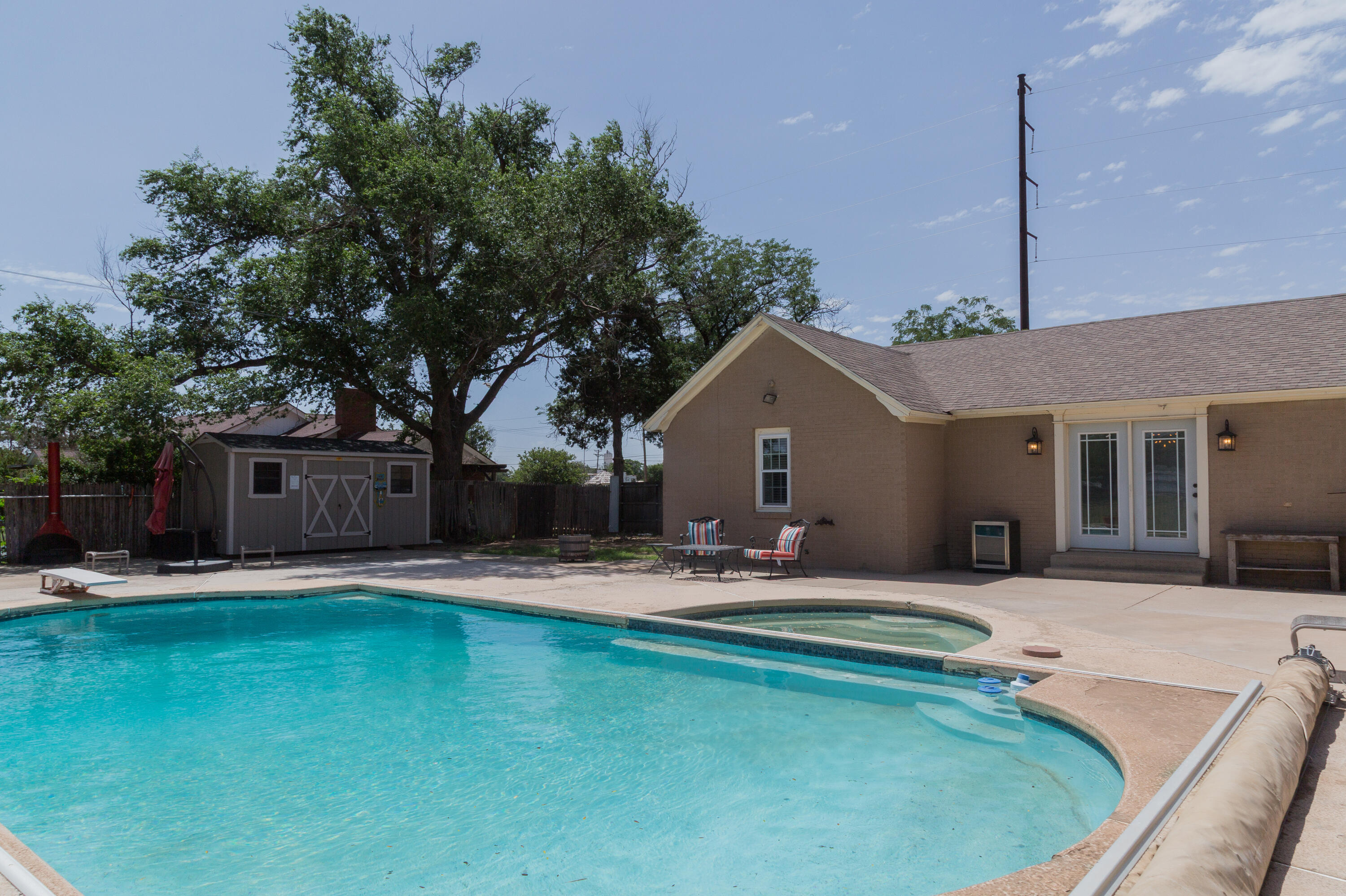1308 West 24th Street Plainview, TX 79072 - Photo 73 of 85 a view of a house with swimming pool and sitting area