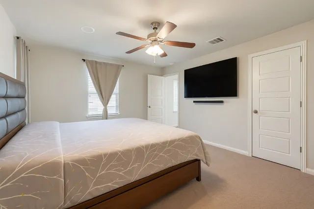 a bedroom with a bed and a chandelier