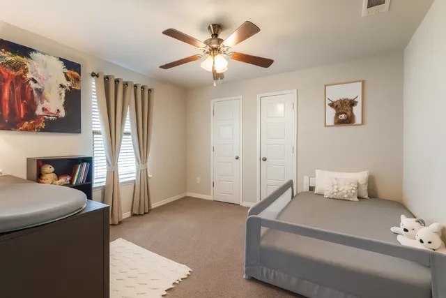 a bathroom with a granite countertop sink a toilet and a mirror