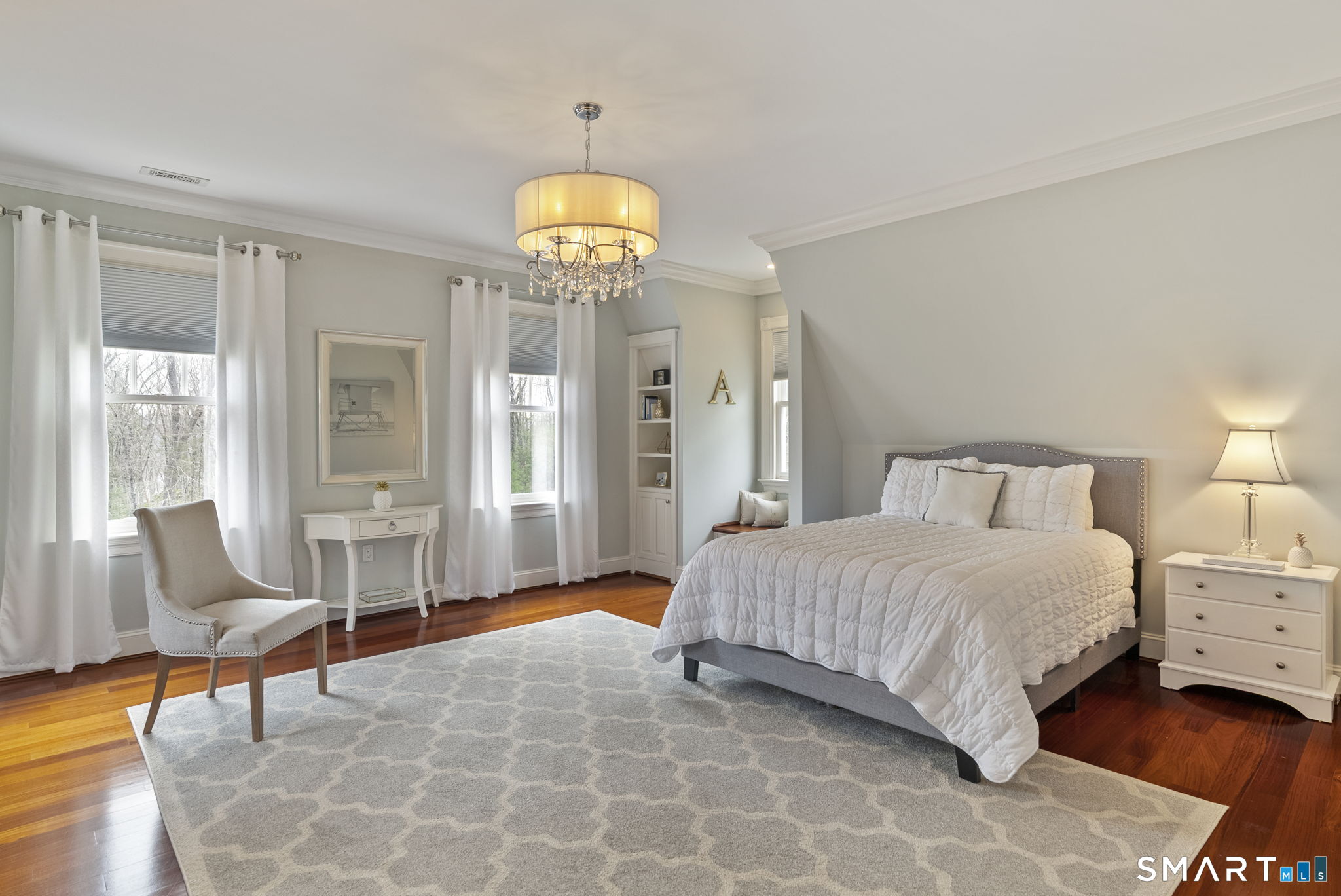 5 Viewpoint Lane Ellington, CT 06029 - Photo 26 of 40 a bedroom with a bed and a chandelier