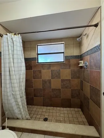 a bathroom with a shower and a sink