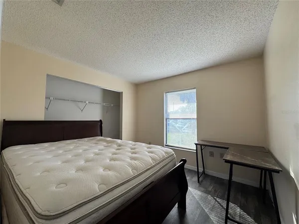 a bed sitting in a bedroom next to a window