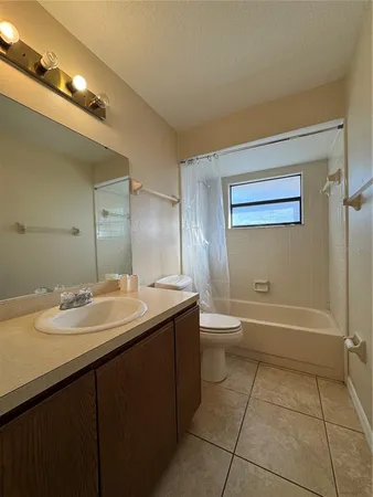 a bathroom with a sink a toilet and bathtub