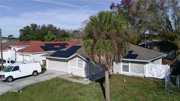 an aerial view of residential house with outdoor space and trees around