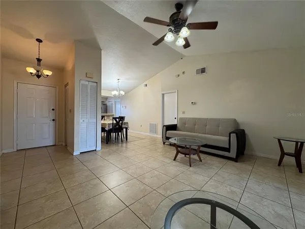 a living room with furniture and a chandelier