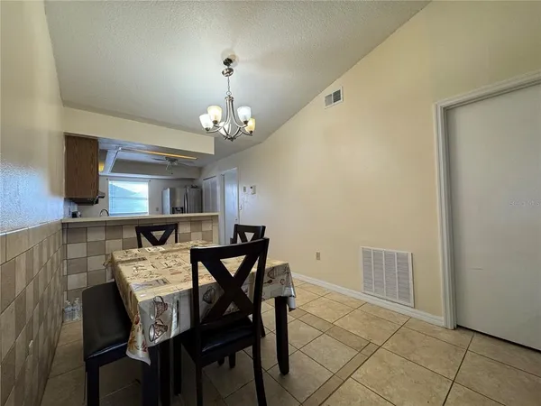 a view of a dining room with furniture and chandelier