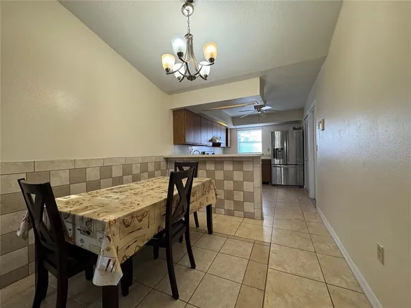 a view of a dining room with furniture and a chandelier