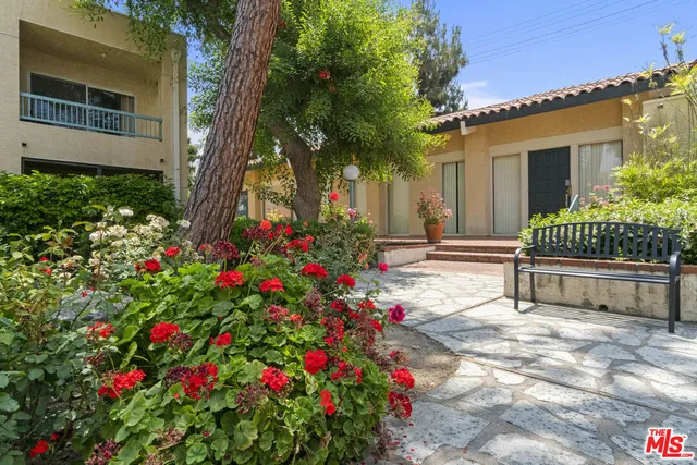 a house with flowers in front of it
