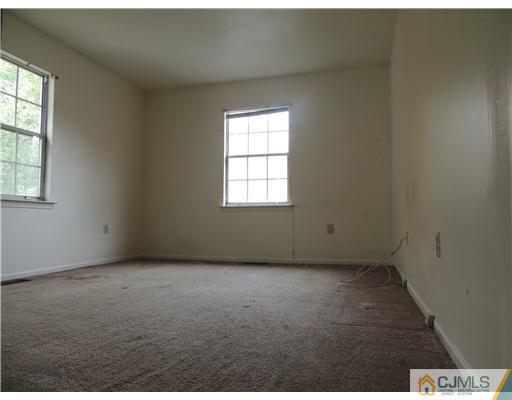 2304 Buckingham Circle Middletown, NJ 07748 - Photo 17 of 25 an empty room with windows