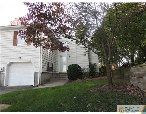 2304 Buckingham Circle Middletown, NJ 07748 - Photo 3 of 25 a view of a backyard with large trees