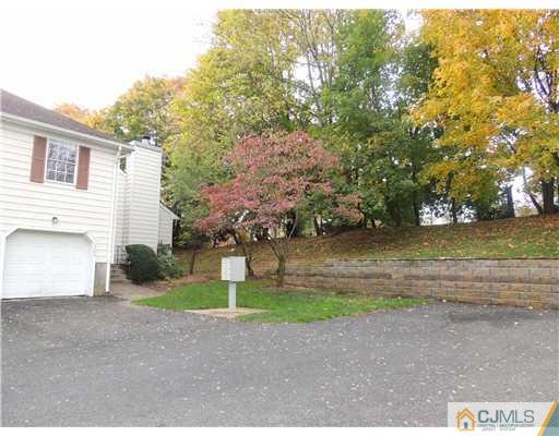 2304 Buckingham Circle Middletown, NJ 07748 - Photo 23 of 25 a front view of a house with a yard and garage