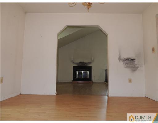 2304 Buckingham Circle Middletown, NJ 07748 - Photo 8 of 25 a view of a livingroom with wooden floor and a hallway