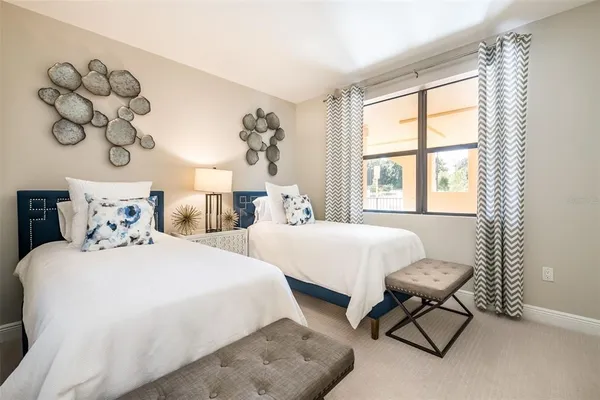 a bedroom with two beds and a window