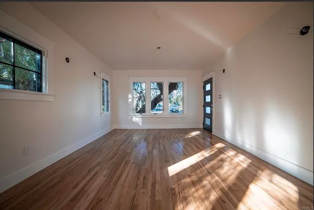 wooden floor in an empty room with a window