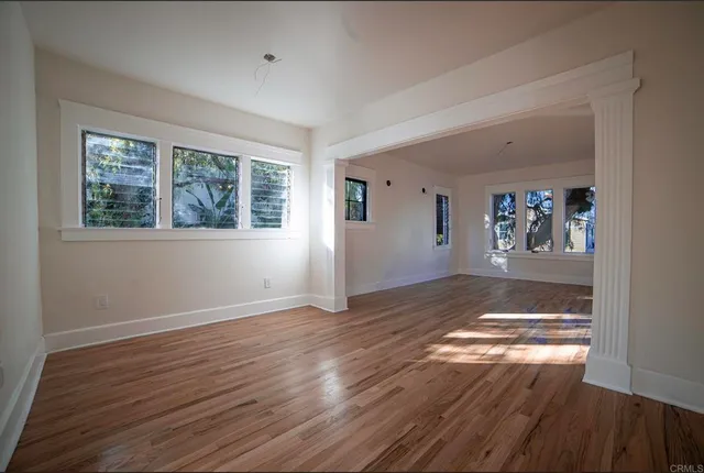 wooden floor in an empty room with a window