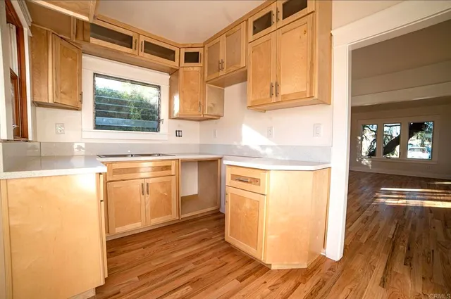 a view of a kitchen counter space and wooden floor