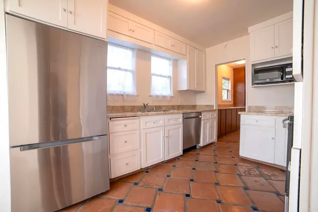 a kitchen with appliances cabinets and a sink