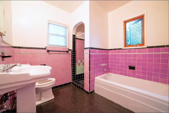 a bathroom with a sink toilet and a mirror