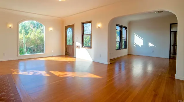 a view of an entryway with wooden floor and a window