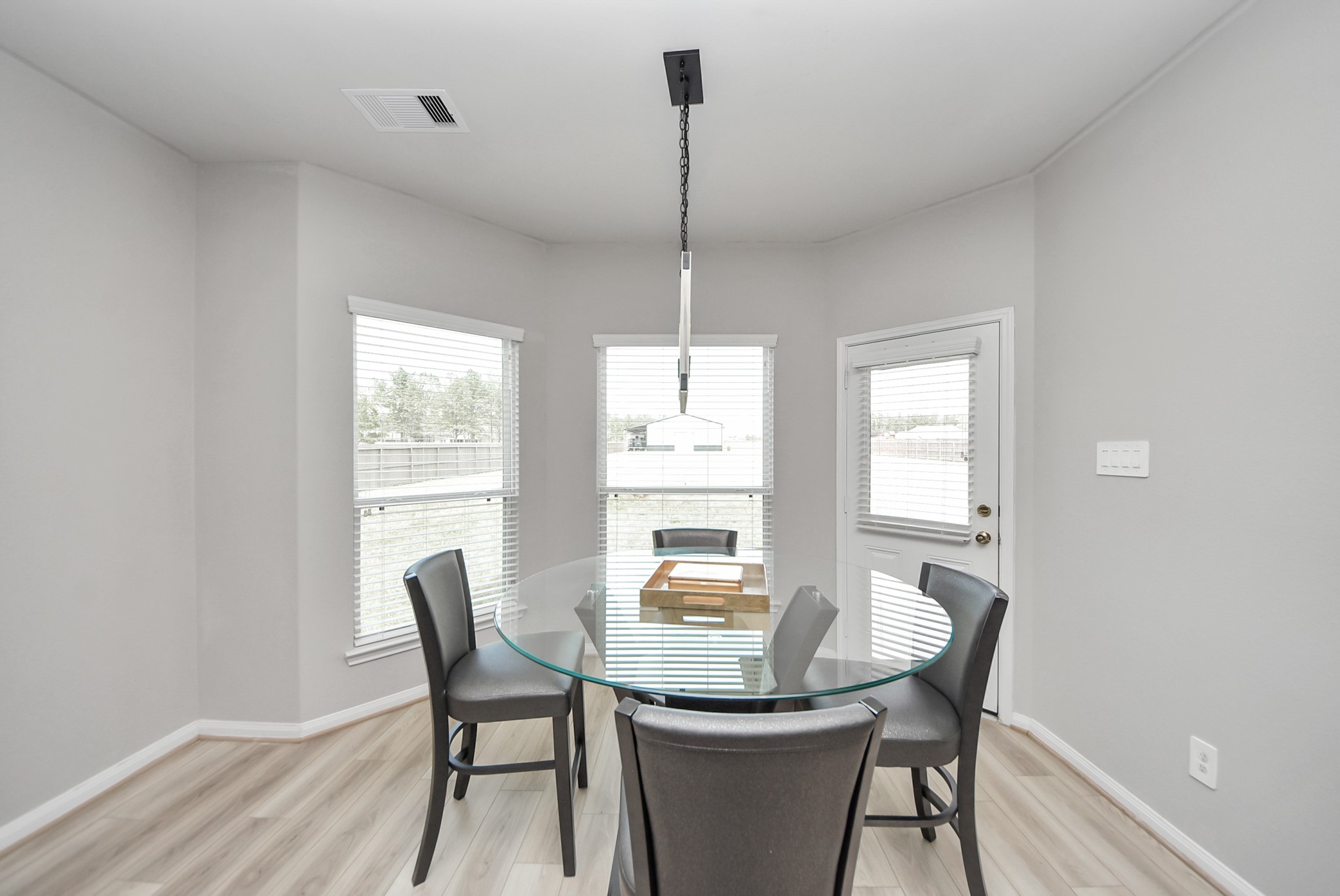 16735 Rockwall Street Conroe, TX 77303 - Photo 11 of 37 a dining room with furniture a chandelier and wooden floor