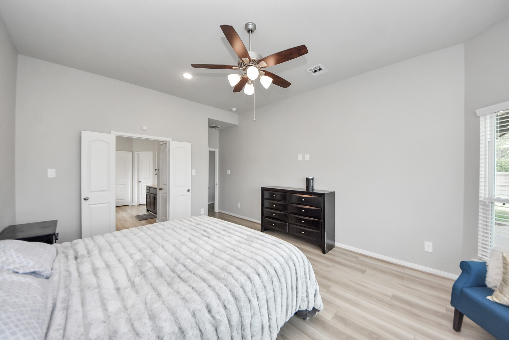 16735 Rockwall Street Conroe, TX 77303 - Photo 16 of 37 a bedroom with a bed and wooden floor